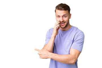 Young handsome caucasian man over isolated chroma key background pointing to the side to present a...