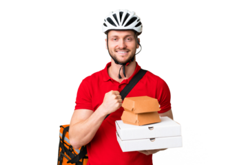 Young delivery man taking a takeaway food over isolated chroma key background celebrating a victory