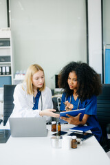  Doctors and nurses using laptops and clipboards, showcasing teamwork, modern healthcare.