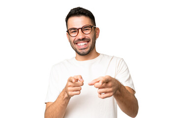 Young handsome caucasian man over isolated chroma key background pointing to the front and smiling