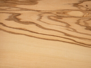 Olive veneer wooden surface with unique wavy grain and natural swirls