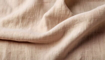 Beige linen fabric with visible fibers and rough texture creating elegant folds