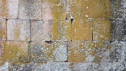 Ancient old brick stone texture pattern background. Ancient castle stone wall in Thailand, a fence made of large stones stacked in many layers.