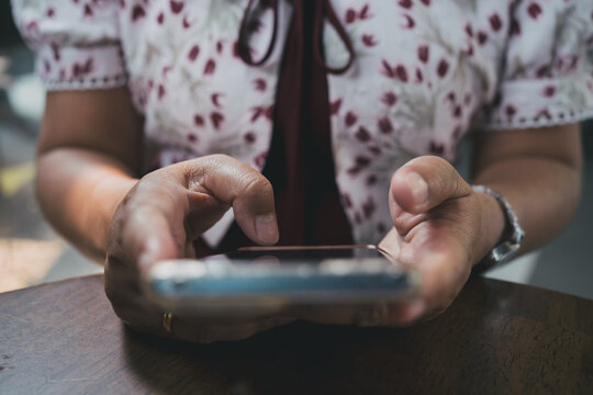 A close up of woman's hand engaging on social media with floating emoji icons. Concept of digital marketing, online engagement, social influence, and modern communication.