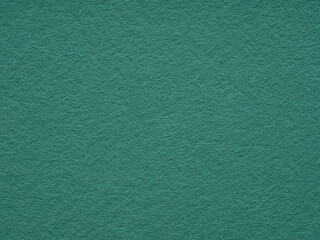 A serene expanse of textured teal felt, imbuing a sense of calm and simplicity