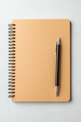 A clean notebook and pen ready for notes and ideas in a minimalist workspace.