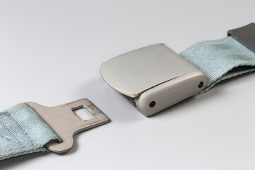 Unfastened buckle of airplane lap seat belt on gray background