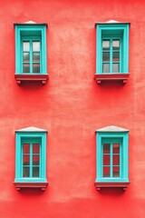 A lively crimson building decorated with delightful teal window frames.