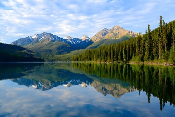 Fototapeta premium Lake reflection mountains and trees under blue sky with light cloud