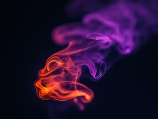 Colorful illuminated smoke trails curling and dancing in the darkness