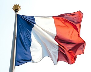 A national flag is waving proudly against a blue sky