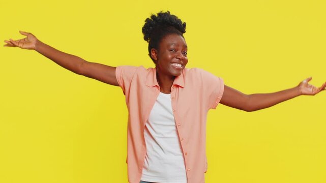 African American woman removes medical protective mask, showing relief and joy, symbolizing recovery from illness. Black girl on yellow background celebrates end of sickness, return to normal life