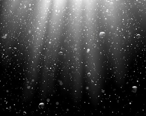 An abstract depiction of glowing light and descending particles