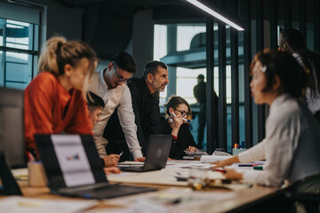 A diverse group of colleagues brainstorm and discuss ideas around a table in a modern office...