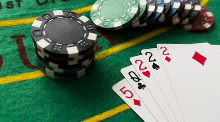 A popular and exciting poker game with a winning combination. Playing cards and chips on a table in a poker club. Advertising space.