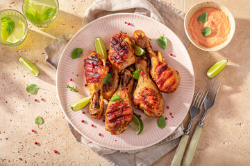 Spicy grilled chicken leg with mustard sauce and lime.