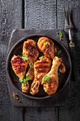 Hot grilled chicken leg with sauces and lime.