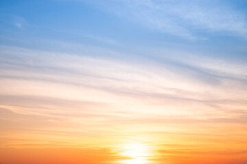 Obraz premium Sky,sunset, beautiful , luxury soft gradient orange gold clouds and sunlight on the blue sky perfect for the background, Sunrise on morning or everning in winter warm time ,Twilight summer,silhouette