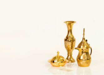 Golden Coffee Pot, Vase, and Golden Accents on a Clean White Surface, A Study in Cultural Tradition and Festive Offering in Soft, Natural Tones
