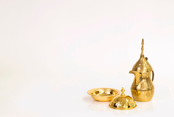 Golden Coffee Pot and Bowl on a Clean White Surface, A Study in Cultural Tradition and Festive Offering in Soft, Natural Tones
