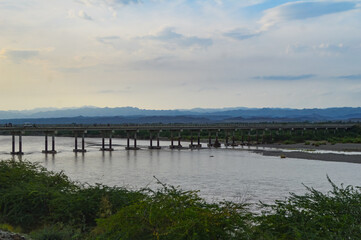 Obraz premium the river in the Baluchistan Turbat bridge Landscape clouds over mountains