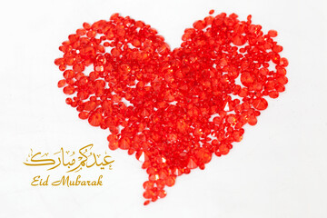 Eid Mubarak greeting card: Sparkling Red Gems as heart shape, with Arabic calligraphy and English...