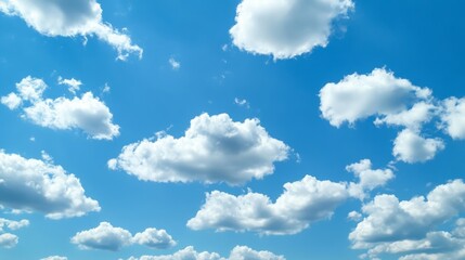 Obraz premium Majestic cloud formations floating across the vast blue sky, creating a serene and tranquil atmosphere. A perfect depiction of nature’s beauty, weather patterns, and atmospheric dynamics.