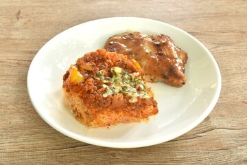 Mexican fried rice with grilled Chicken dressing spicy chop tomato and onion sauce on plate