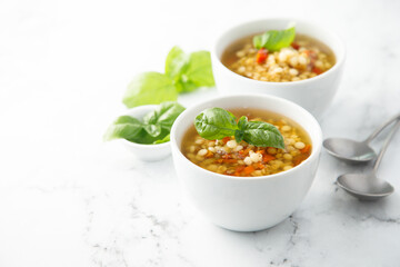 Vegan lentils soup with fresh basil