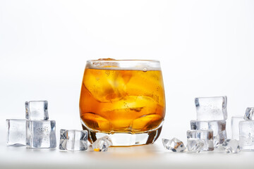 Sparkling drink. A glass of apple spritzer or Apfelschorle on a white background. Cold carbonated apple juice. Homemade spritzer served with ice.