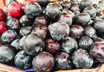 A pile of ripe delicious plum open sell in Indian market.