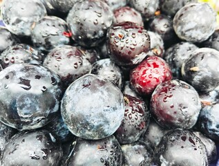 A pile of ripe delicious plum open sell in Indian market.