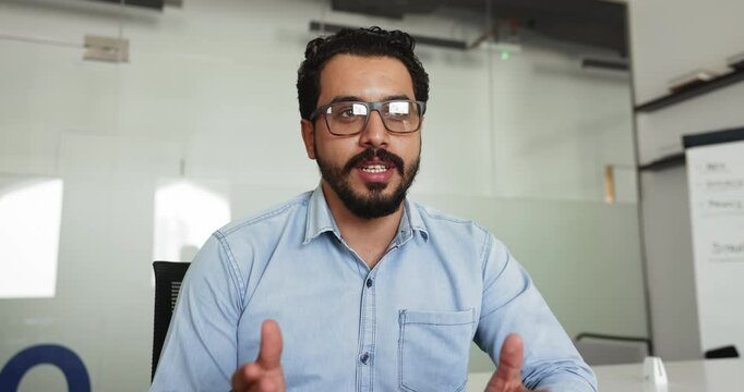 Close up of young 30s Arabic businessman participate in virtual meeting event to solve business-related matters, provide professional consultation, communicates with client remotely via videocall app