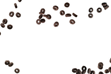 Chocolate rings cereal spill out into a bowl. Breakfast.