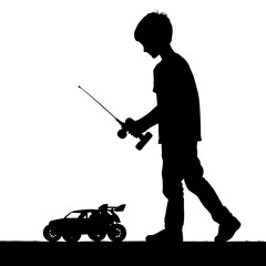 Child playing with remote-controlled car in silhouette  