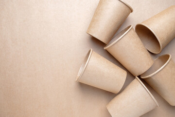 Group of brown paper cups on brown paper background, recycled cup for hot and cold drink