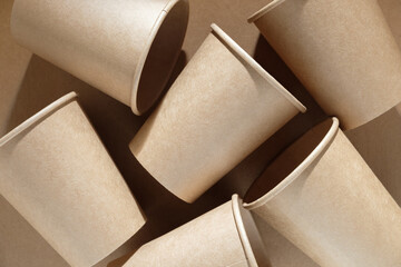 Group of brown paper cups on brown paper background, recycled cup for hot and cold drink