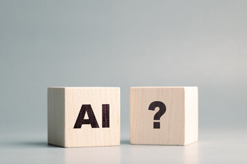 AI text and Question mark symbol on the wooden cubes, confusion about AI, how to use, and ask,...