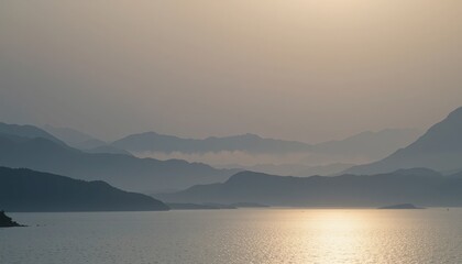 Fototapeta premium Serene sunset over misty mountains scenic lake view nature photography tranquil environment wide angle perspective