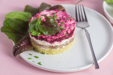 Salad with herring and beets in a plate. Salad Herring under a fur coat