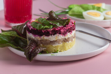 Salad with herring and beets in a plate. Salad Herring under a fur coat