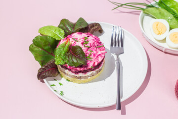 Salad with herring and beets in a plate. Salad Herring under a fur coat