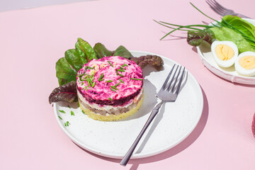 Salad with herring and beets in a plate. Salad Herring under a fur coat