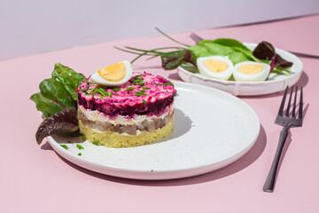 Salad with herring and beets in a plate. Salad Herring under a fur coat