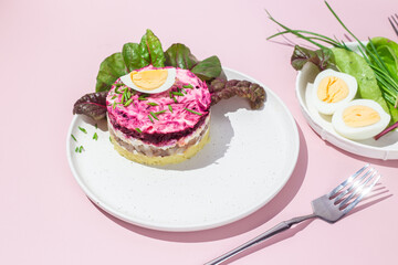 Salad with herring and beets in a plate. Salad Herring under a fur coat