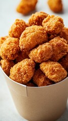 Golden fried chicken bites overflowing in a brown paper bucket crispy delicious appetizer for fast food lover close up shot
