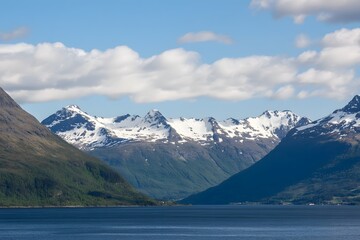 Fototapeta premium Valley of water, snow capped mountains, blue sky, fluffy clouds