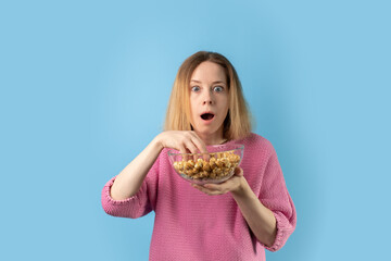 woman with popcorn, surprised expression, sweet treat and dramatic joy, crunchy snack