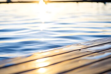 Wood pier edge meeting clear water; sunshine reflects. Soft bokeh background
