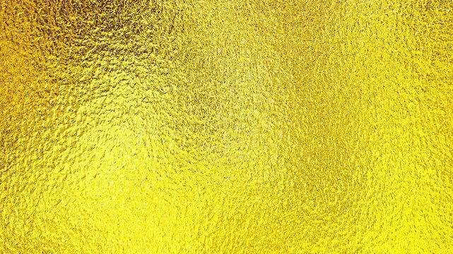 luxury gold foil grainy gradient brass golden yellow metallic surface background panning video
